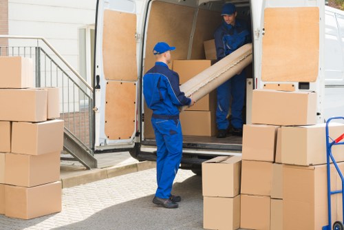 Van moving team handling boxes safely during a relocation